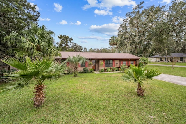 single story home featuring a front lawn