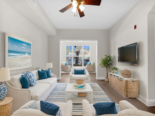 living room with baseboards, ceiling fan, wood finished floors, and visible vents