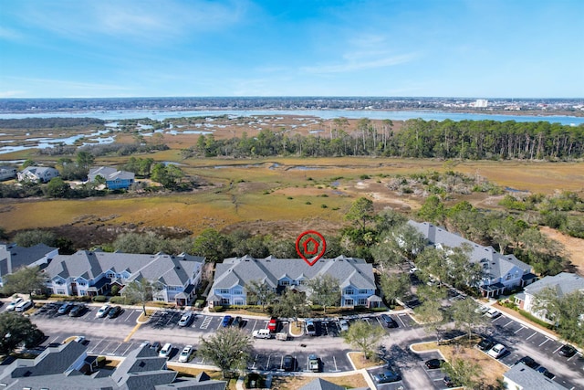 drone / aerial view featuring a water view and a residential view