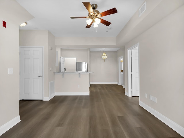 unfurnished living room with visible vents, baseboards, and ceiling fan