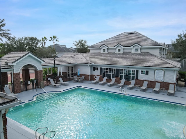 community pool featuring a patio area and fence