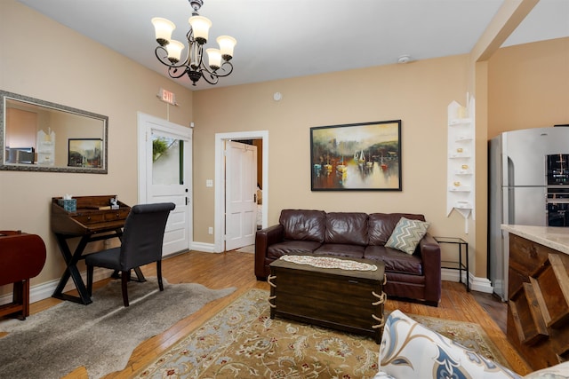 living room featuring light hardwood / wood-style floors and an inviting chandelier