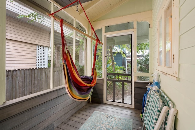 sunroom / solarium with a healthy amount of sunlight and lofted ceiling