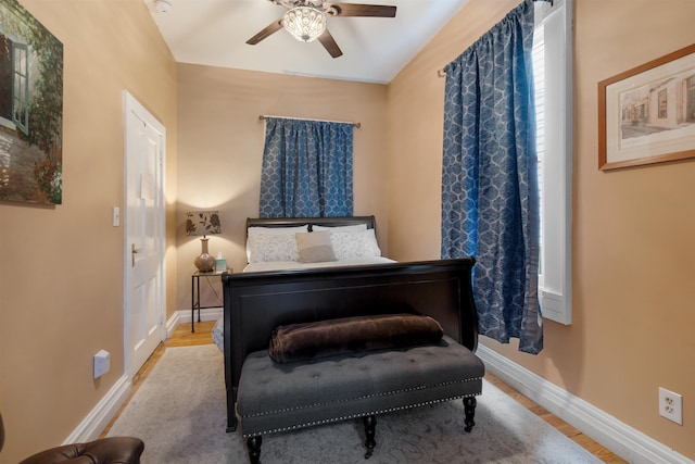 bedroom with light wood-type flooring and ceiling fan