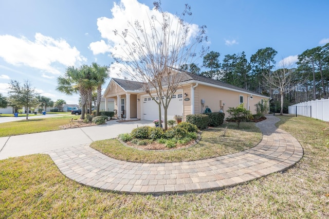 view of front of house featuring a garage, a front yard, fence, and driveway