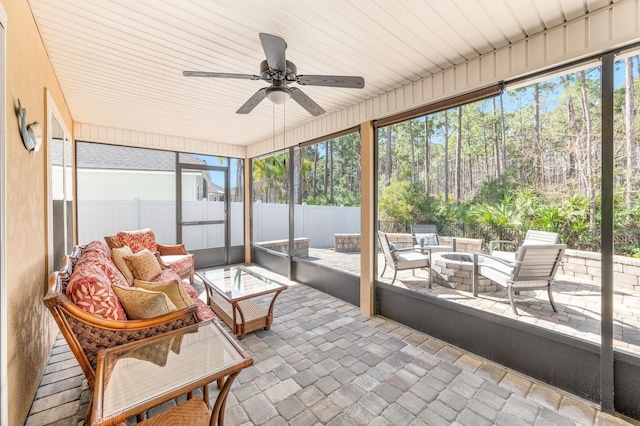 sunroom featuring ceiling fan