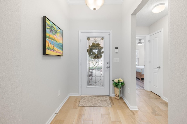 foyer featuring baseboards and light wood finished floors