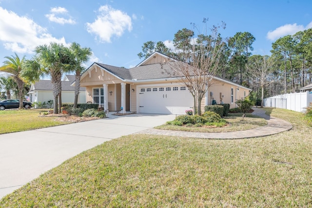 view of front of property featuring driveway, an attached garage, fence, and a front lawn