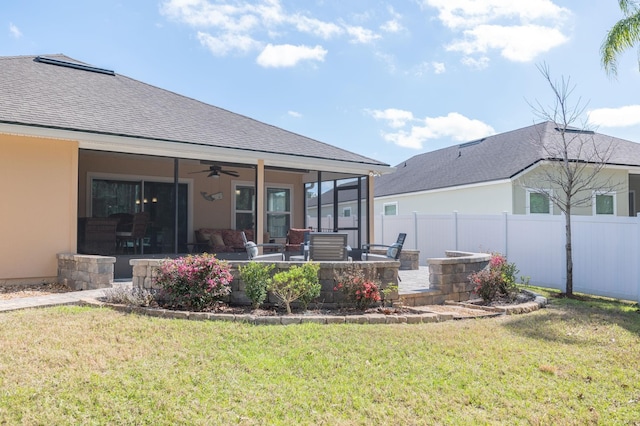 back of house featuring a ceiling fan, a patio area, a yard, and fence