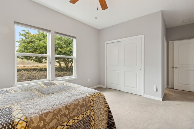 bedroom with a closet, carpet, a ceiling fan, and baseboards