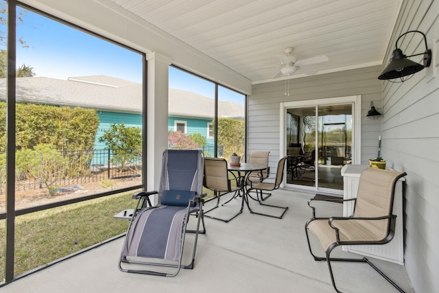 sunroom / solarium featuring ceiling fan