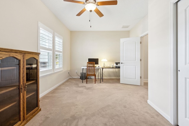 office area featuring visible vents, carpet, a ceiling fan, and baseboards