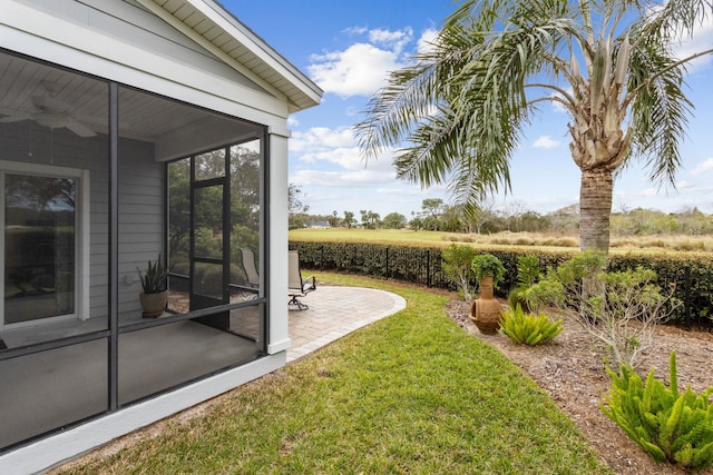 view of yard featuring a sunroom and a patio