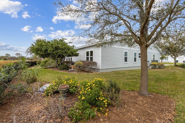 view of home's exterior with a lawn