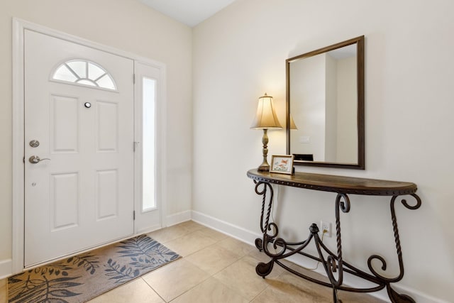 entryway featuring light tile patterned floors and baseboards