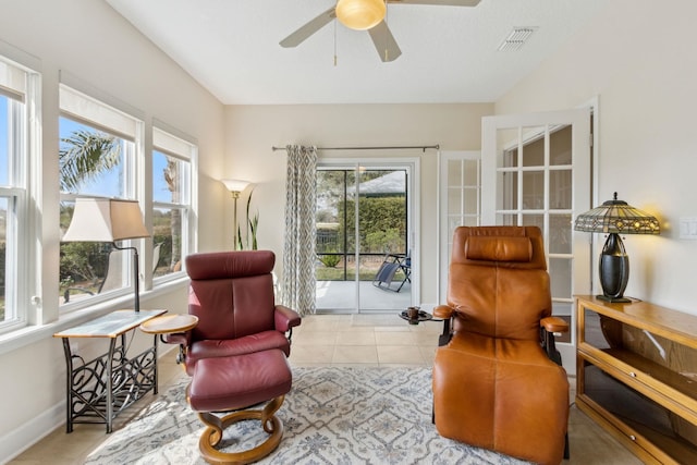 sitting room featuring visible vents, ceiling fan, baseboards, and tile patterned floors