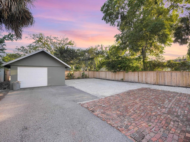 view of garage at dusk