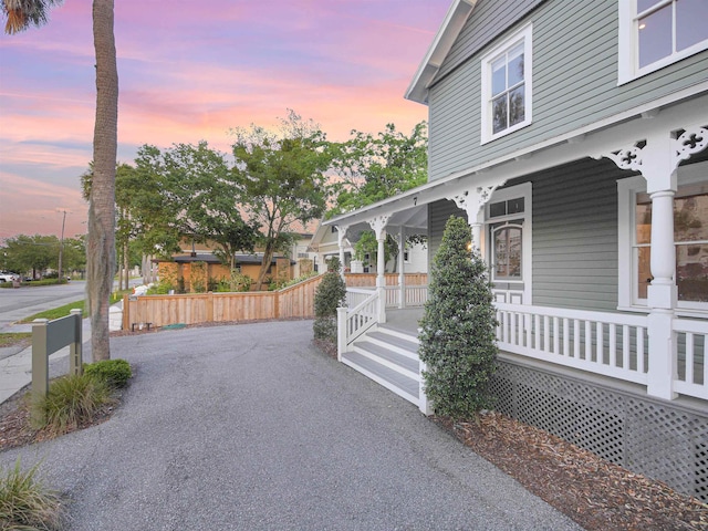 property exterior at dusk with covered porch