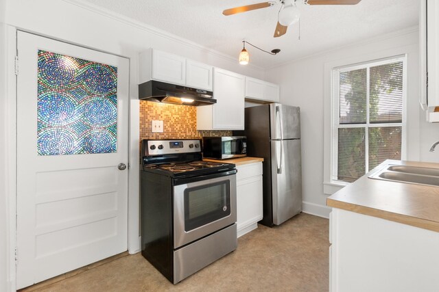 kitchen with light carpet, appliances with stainless steel finishes, white cabinetry, and sink