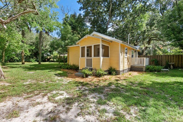 view of property exterior with a yard