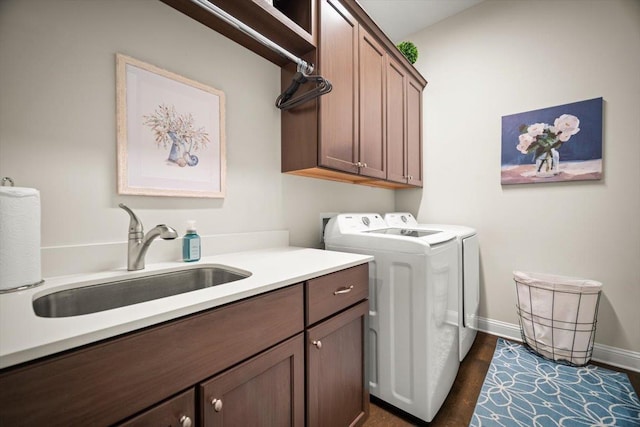 118 Lamego Ln, Saint Augustine, FL 32095 - clothes washing area featuring separate washer and dryer, a sink, baseboards, dark wood-style floors, and cabinet space