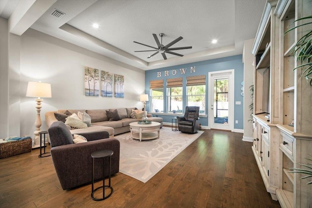 118 Lamego Ln, Saint Augustine, FL 32095 - living area with visible vents, a raised ceiling, dark wood-style floors, and a ceiling fan