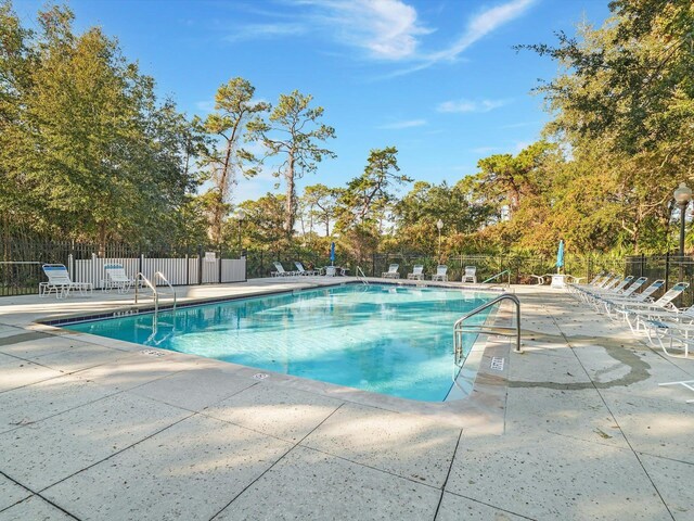 7 Andalusia Ct, Saint Augustine, FL 32086 - community pool with a patio and view of wooded area