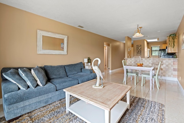 650 W Pope Rd Unit 208, Saint Augustine, FL 32080 - living room featuring light tile patterned floors and baseboards