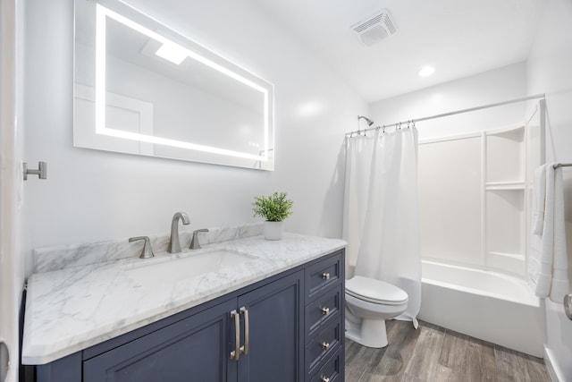 full bathroom featuring shower / bathtub combination with curtain, toilet, vanity, and hardwood / wood-style flooring