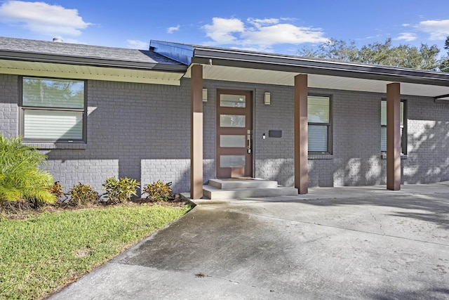 view of exterior entry with a porch