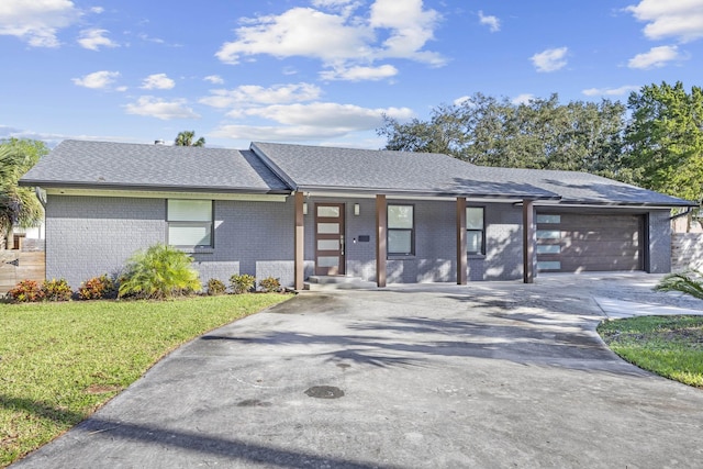50 Dufferin St, Saint Augustine, FL 32084 - view of front of home with brick siding, a front yard, a garage, concrete driveway, and a porch