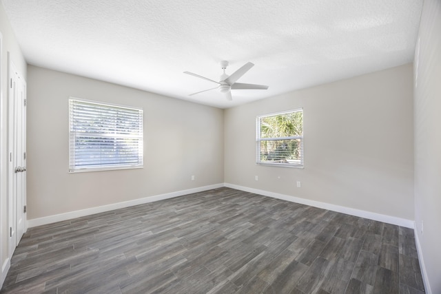 empty room featuring ceiling fan, dark hardwood / wood-style flooring, and a textured ceiling