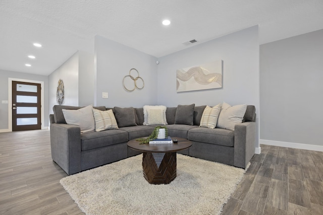 living room with hardwood / wood-style floors and a textured ceiling