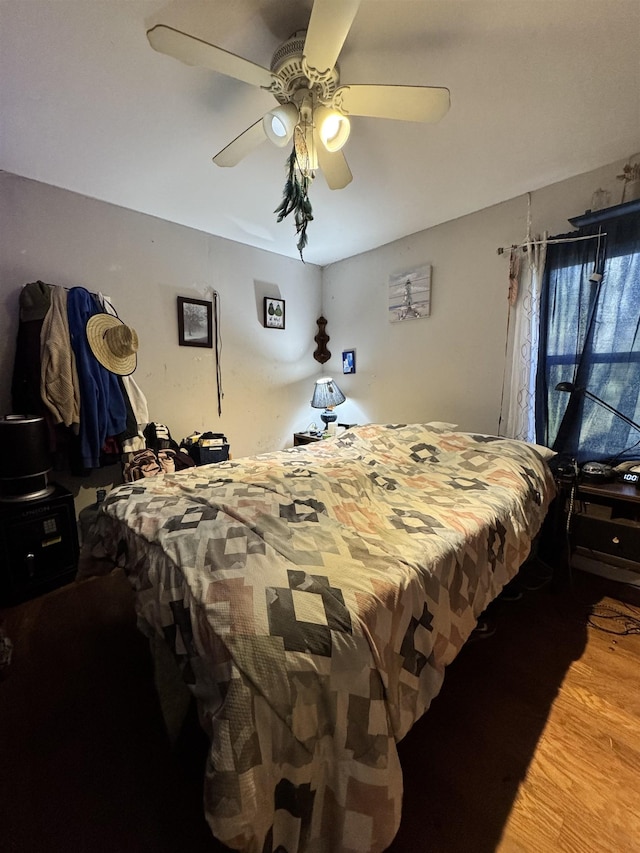 bedroom featuring ceiling fan and wood-type flooring