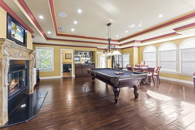 playroom featuring dark hardwood / wood-style flooring, a tray ceiling, crown molding, and pool table