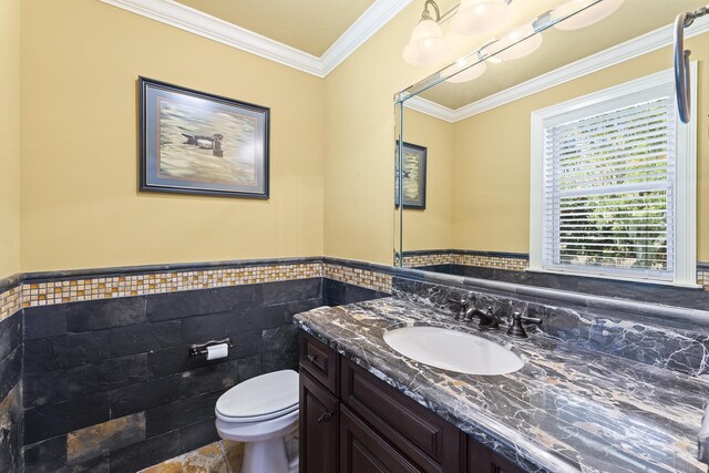 bathroom featuring crown molding, vanity, tile walls, and toilet