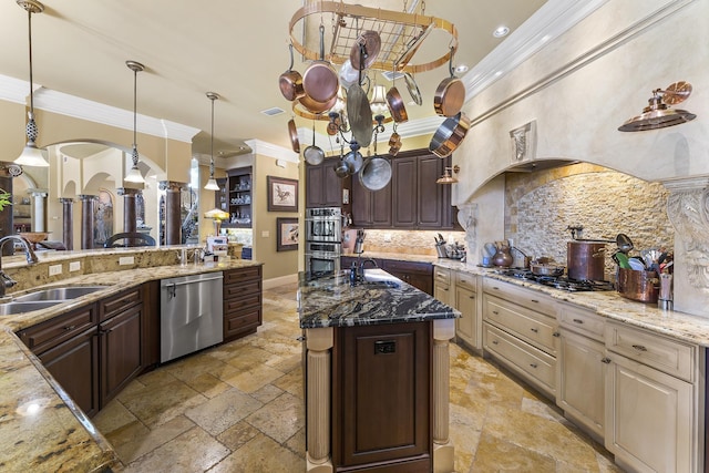 kitchen featuring appliances with stainless steel finishes, dark brown cabinets, dark stone countertops, and sink