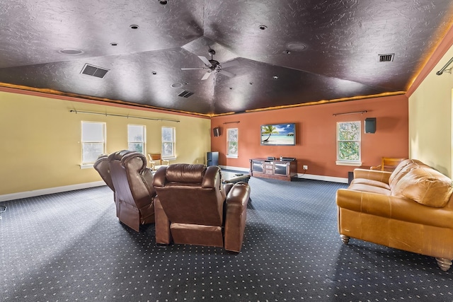 home theater featuring carpet, ceiling fan, lofted ceiling, and a textured ceiling