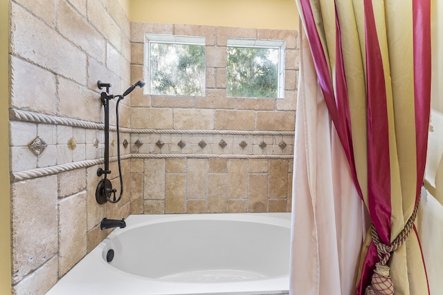 bathroom with shower / bath combo with shower curtain