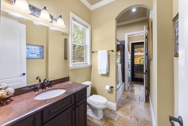 bathroom with vanity, toilet, an enclosed shower, and ornamental molding