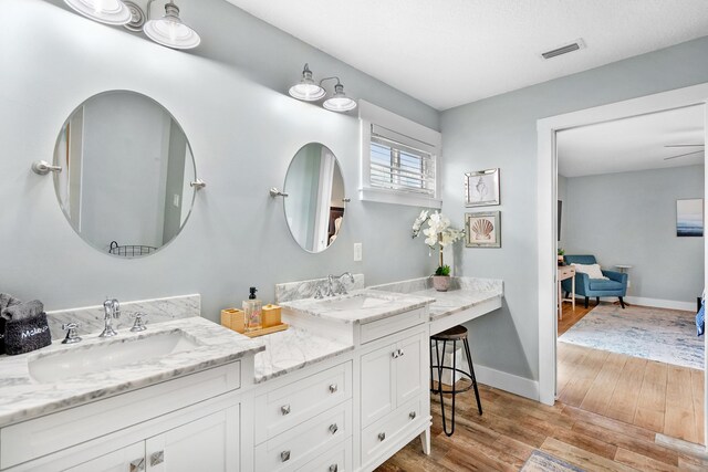 7201 A1A S, Saint Augustine, FL 32080 - full bathroom featuring double vanity, baseboards, a sink, and wood finished floors