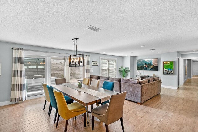 7201 A1A S, Saint Augustine, FL 32080 - dining space with a chandelier, visible vents, light wood-type flooring, and baseboards