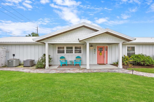 7201 A1A S, Saint Augustine, FL 32080 - view of front of property with a front yard, central AC, and board and batten siding