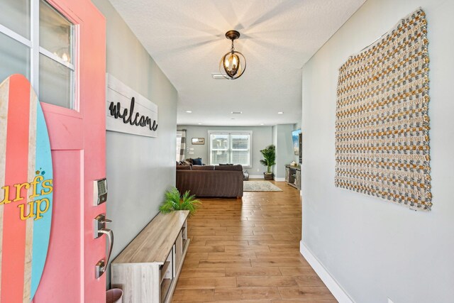 7201 A1A S, Saint Augustine, FL 32080 - hall with baseboards, light wood-style floors, and a textured ceiling