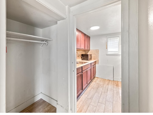 kitchen with light hardwood / wood-style flooring and sink