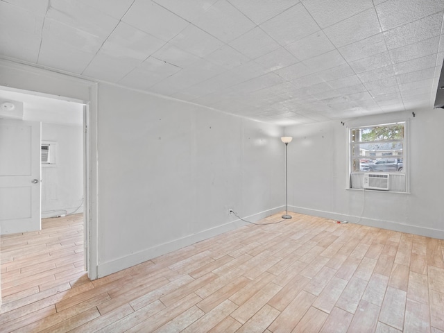 empty room with light wood-type flooring and cooling unit