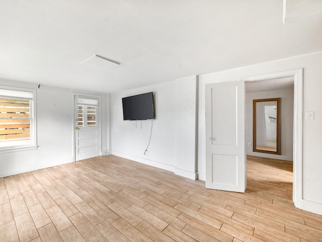 unfurnished room with light wood-type flooring