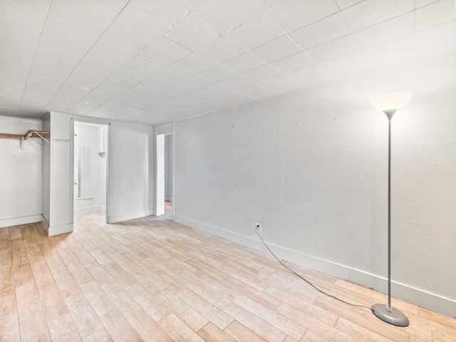 basement with light hardwood / wood-style floors