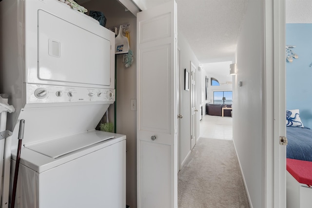 2900 Coastal Hwy, Saint Augustine, FL 32084 - laundry room with stacked washing maching and dryer, carpet flooring, and laundry area