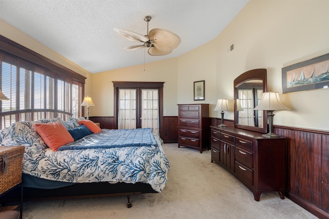 2900 Coastal Hwy, Saint Augustine, FL 32084 - bedroom featuring lofted ceiling, visible vents, a wainscoted wall, and wood walls